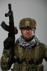 Image of soldier in safety glasses with gun in his hand