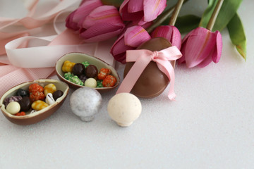 Obraz na płótnie Canvas Easter composition with chocolate eggs on color white background,