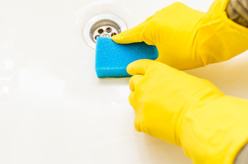 cleaning bathroom in rubber gloves