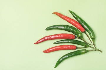 Colorful Mix of Chili Pappers on Green Background Flat Lay Top View Copy Space