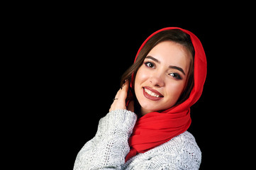 Young beautiful woman in a red scarf on dark background