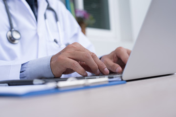 Fototapeta premium Doctor working on laptop computer