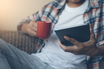 Male hipster using digital tablet computer at home
