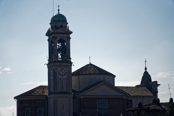 Obraz premium Catholic church, Robecco sul Naviglio, Milan province, Italy, 13 March 2018: Old Catholic church with bell tower, religion background