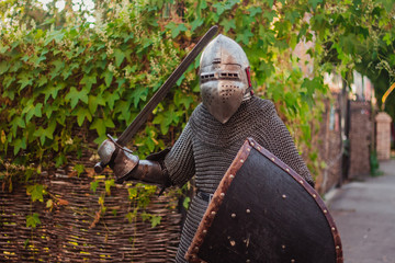 A man with a gun, a stern look. Knight in armor in the castle. Medieval photo illustrations....