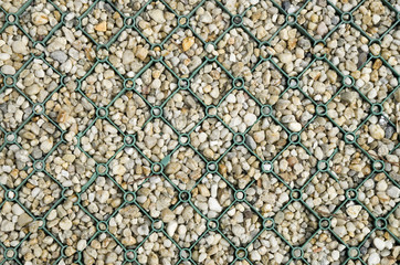 Green plastic grid with gravel in the parking lot