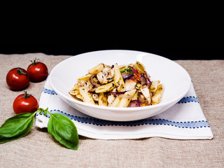 Pasta with pesto sauce and nuts on a the table