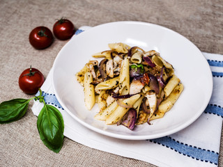 Pasta with pesto sauce and nuts on a the table