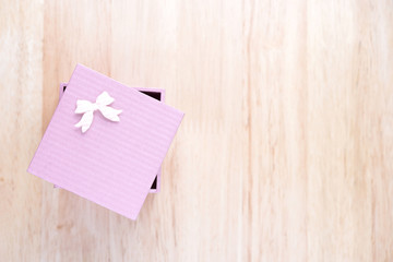 pink gift box on wooden table