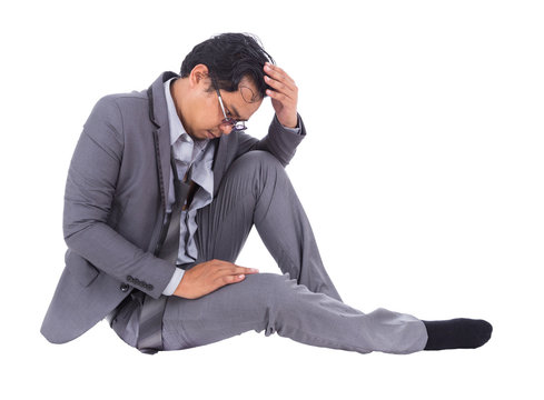 stressed businessman touching his head and thinking isolated on white