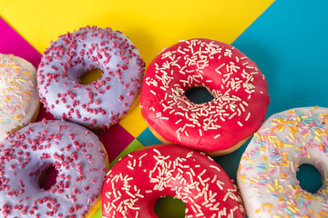 donuts on a beautiful colored background, pastel glamor colors