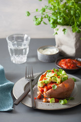 baked sweet potatoes with avocado chili salsa and beans