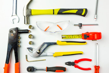 Set of construction tools on white background as wrench, hammer, pliers, socket wrench, spanner, tape measure, electric drill,safety glasses, screwdrive