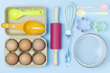 Baking utensils tool pastel style on blue background topview flatlay.