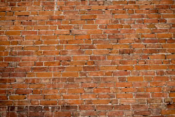 Old red brick wall background texture close up