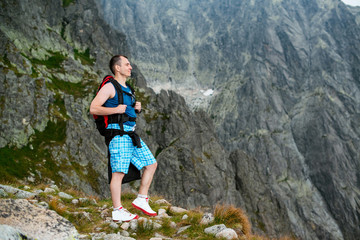 Naklejka na ściany i meble Young man enjoying beautiful view of mountains.