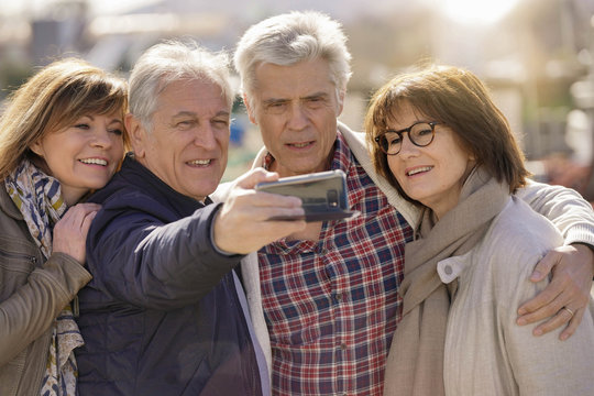 Portrait of happy senior people taking selfie picture