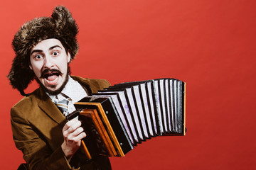 a very positive man with an accordion posing in the studio