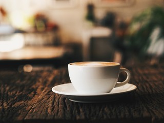 close up coffee latte art on wooden table.