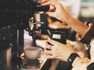 Fototapeta na wymiar Close up barista hands with coffee machine.