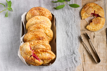 Crispy mini pies with apple and red currant. Rustic style.