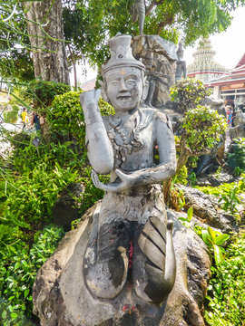 Bangkok, Thailand - Circa January 2018: Stone statue depicting a Reusi Dat Ton (Thai Yoga) pose at famous Wat Pho (Buddhist Temple)