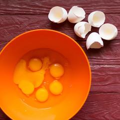 Ingredients for baking - broken eggs, flour.