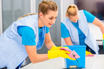 Commercial cleaning crew ladies working as team in office