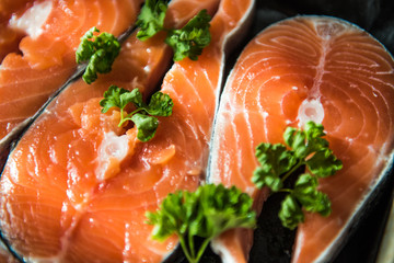the fresh fish stakes with greens which are laid out on a baking sheet sunlight