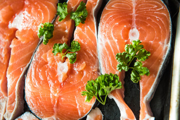 the fresh fish stakes with greens which are laid out on a baking sheet sunlight