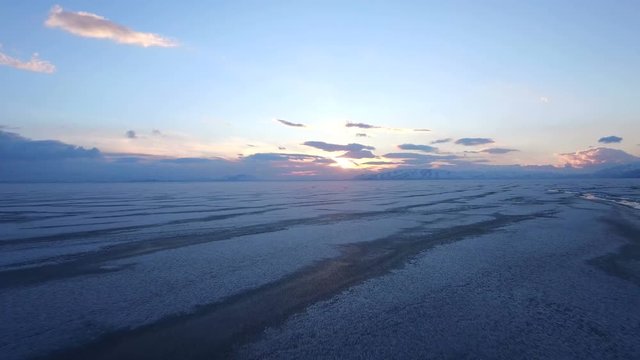 Flying over iced sea or lake by helicopter .