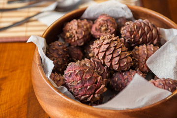 Pine cone on the wooden plate