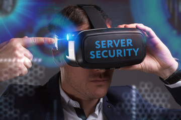 Business, Technology, Internet and network concept. Young businessman working in virtual reality glasses sees the inscription: Server security