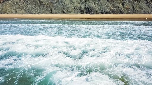 Aerial Drone View Of Ocean Waves And Beautiful Sandy Beach in Slow Motion