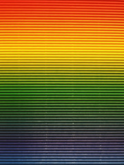 Corrugated rainbow color paper background texture. (the gradient red, yellow, green and blue color on paper)