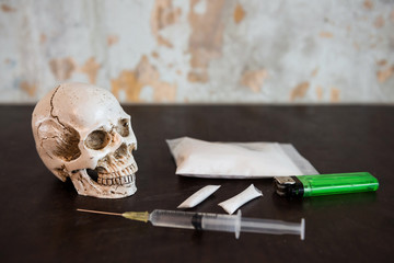 skull with heroin drugs and syringe