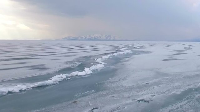 Flying over iced sea or lake by helicopter .