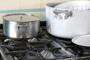 pots on the stove in the industrial kitchen of a company canteen during meal preparation