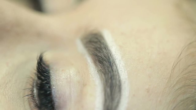 Close up of cosmetologist making microblading procedure.
