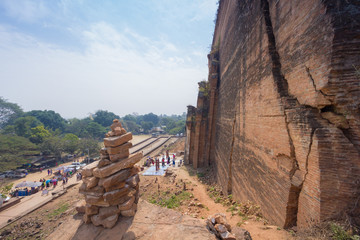 Brick stacking built to worship to the Mingun pagoda with tourist background below, Mingun, Sagaing Region, Myanmar