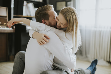 Loving couple kissing in the room