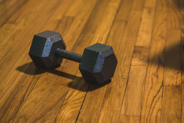 dumbbell weight on hardwood floor