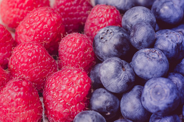 close up of raspberries and blueberries