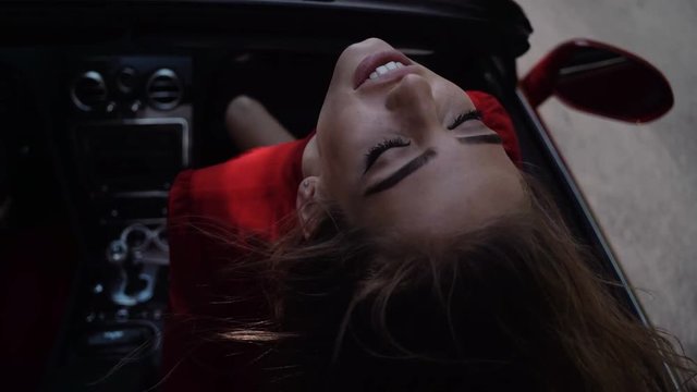 f beautiful sexy fashion girl model with bright makeup in luxury car. Beautiful woman enjoying ride in convertible vintage car on road trip with outstretched arms.