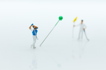 Miniature people : Businessmen spend their free time for Golf activities. Image use for sport, hobbies concept.