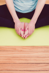 female working out doing yoga poses one yoga mat