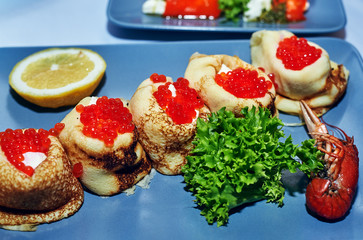 Pancakes with red caviar . Traditional Russian snack