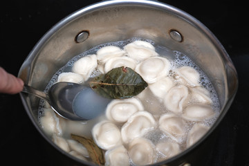 Fototapeta na wymiar Boiling dumplings in the pan