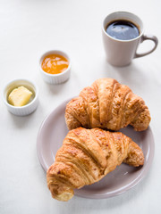 Continental breakfast with French croissants, butter, jam and black coffee