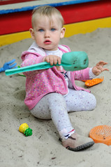 Fototapeta premium Small child in sandbox outdoors